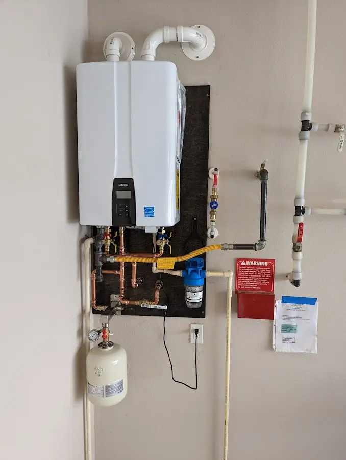 Professional plumber installing copper piping in a Cottage Lake home